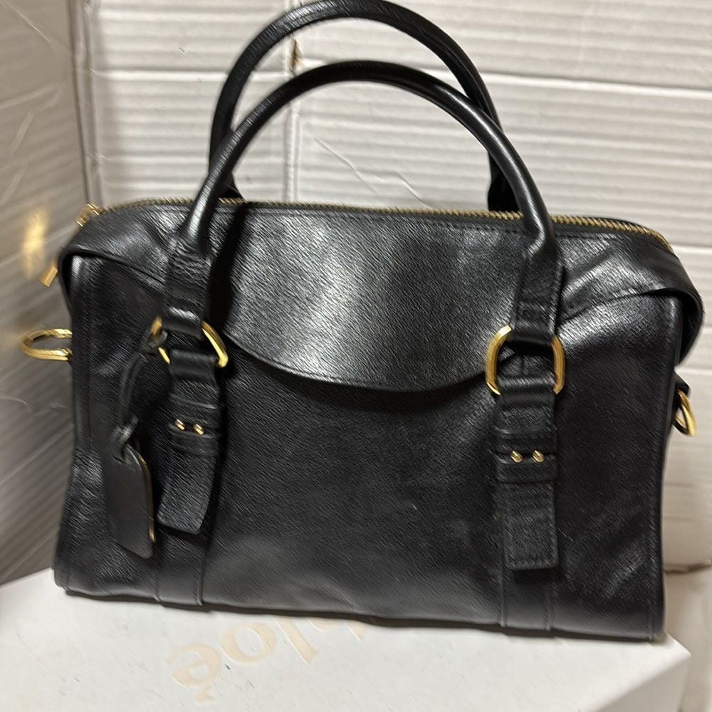 Levity leather satchel with rolled handles and gold tone hardware